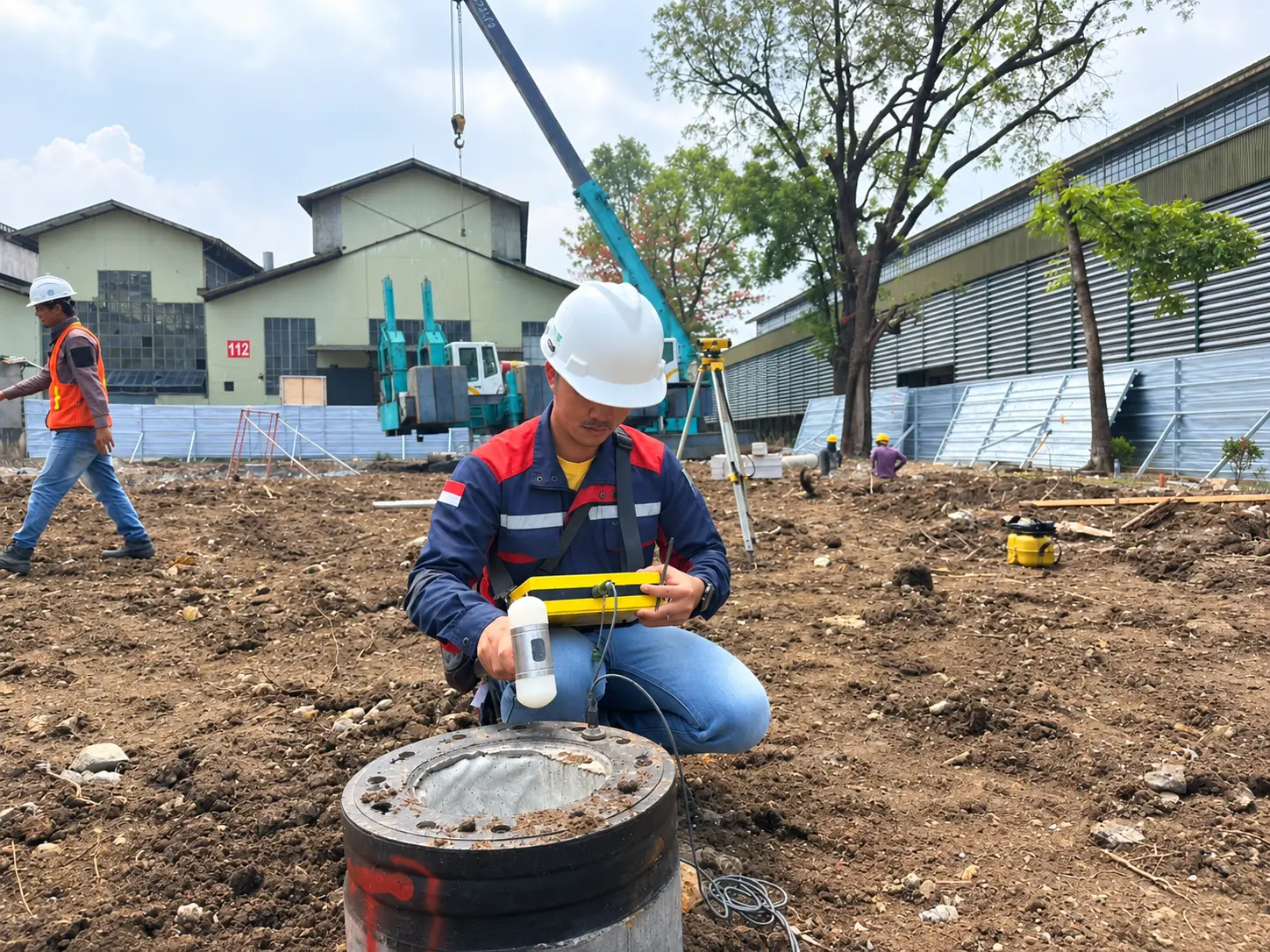 Proses pengujian Pile Integrity Test dengan hand hammer dan receiver pada kepala tiang